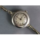 An early 20th century ladies’ wristwatch, the small silvered circular dial with black roman