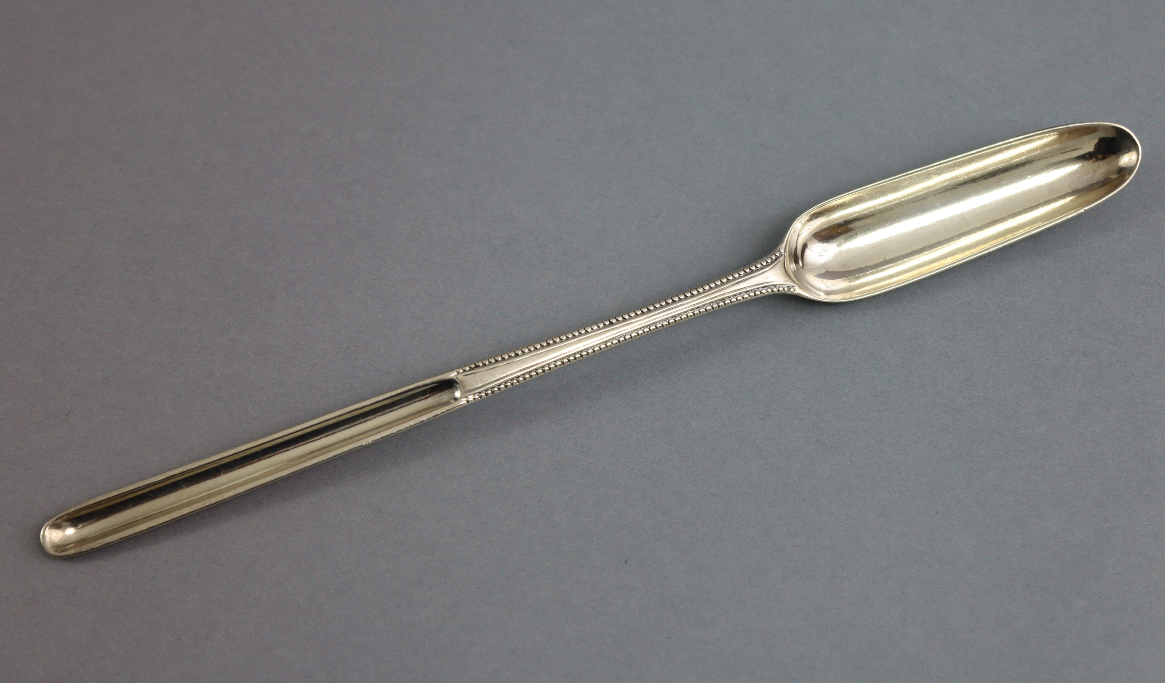 A George III silver Bead pattern double-ended marrow scoop, 8¾” long; London 1783, by George Smith