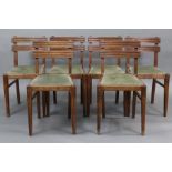 A set of six early 20th century oak dining chairs with fluted rail backs, padded drop-in seats, & on