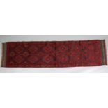 A Meshwari runner of dark blue ground with all-over repeating geometric design in red, ivory, &