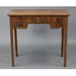 A George III mahogany lowboy with crossbanded overhang top, fitted three frieze drawers with brass