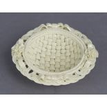 A Belleek porcelain three-stand basket dish with ribbon & flowers to the rim, 5” diam. (brown