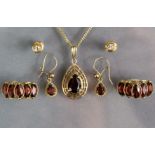 A pear-shaped garnet pendant in 9ct. gold cage mount, on 9ct. gold fine-link chain necklet (3.
