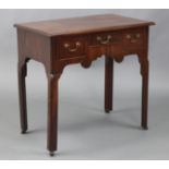 A George III mahogany lowboy with moulded edge to the rectangular overhang top, fitted three