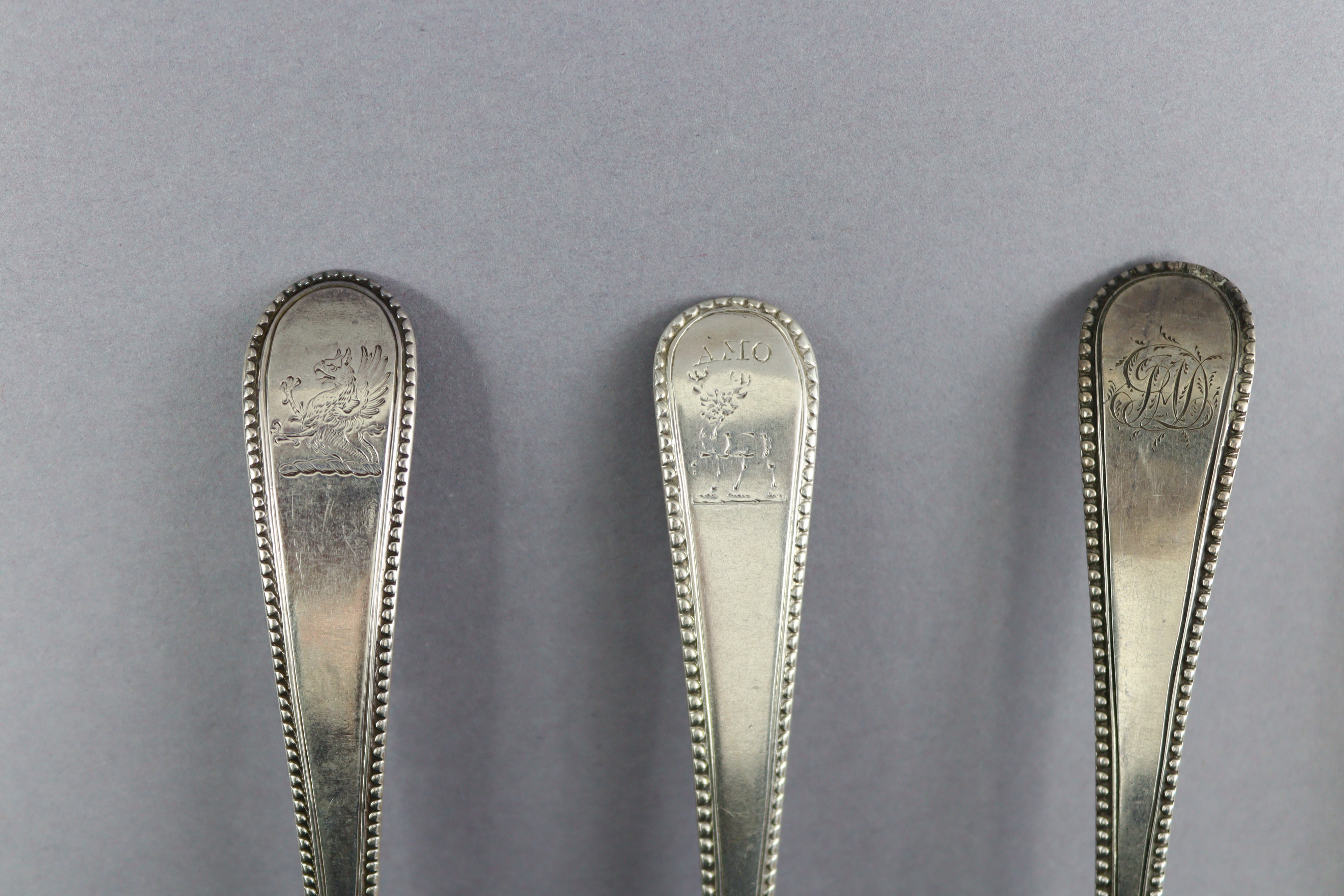 Eight George III silver Old English Bead pattern table spoons; London 1777 by Thos. Northcote, two - Image 5 of 7