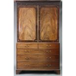 A late 18th century figured mahogany linen press, fitted six oak sliding trays enclosed by pair of