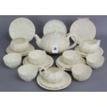 A Belleek porcelain Tridacna pattern white-glazed tea set comprising a teapot (un-marked), milk jug,
