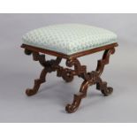 A Victorian walnut rectangular stool with padded seat, on carved scrolling X supports with turned