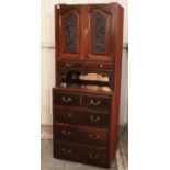 A late Victorian mahogany wardrobe section enclosed by pair of carved panel doors above two