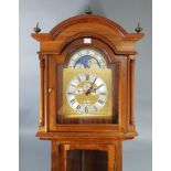 A reproduction West German longcase clock with moon phase dial, & in mahogany–finish case, 81”