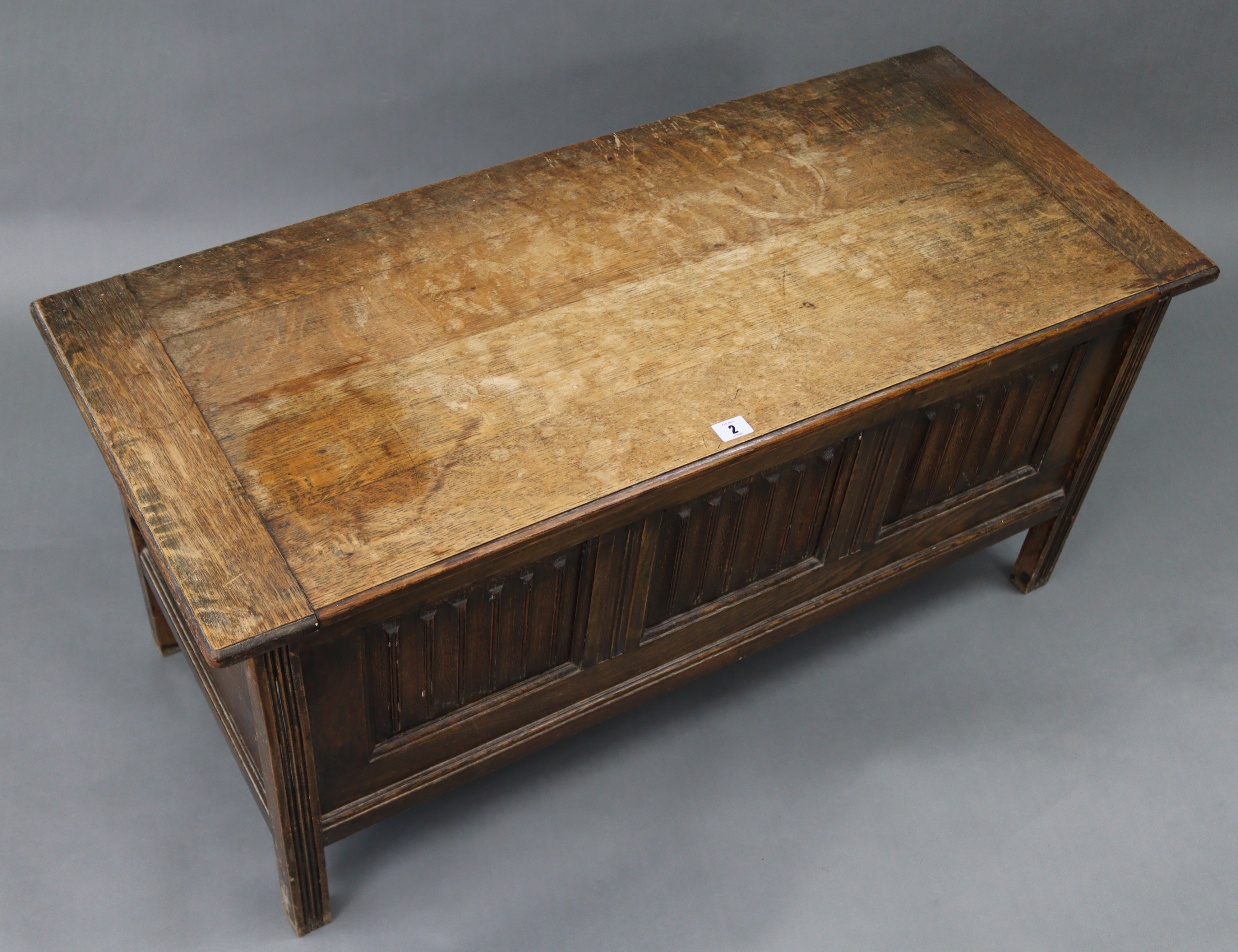 An oak coffer with hinged lift-lid, linen-fold panel front, & on short square legs, 42” wide x 20” - Image 3 of 3