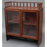 A Victorian mahogany small standing bookcase with spindle gallery to the top, & fitted centre