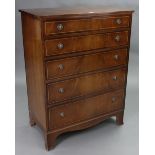 An inlaid-mahogany chest, fitted five long graduated drawers with brass ring handles, & on shaped