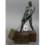 A contemporary Limited-Edition bronzed statue depicting a male figure pulling a block on a chain (