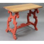 A Spanish-style kitchen table with light oak rectangular top, the crimson painted underside on