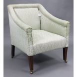 An Edwardian small square-back easy chair upholstered green damask, & on short square tapered legs