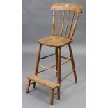 An elm spindle-back clerk’s highchair with hard seat, &on turned legs with spindle stretchers.