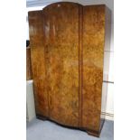 183. A mid-20th century burr-walnut finish wardrobe, enclosed by bow-fronted centre panel door, & on