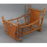 An oak & plywood baby’s cradle, 24¾” long x 17” high.