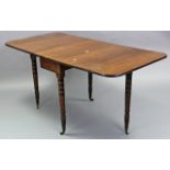 A late Victorian mahogany drop-leaf dining table on four ring-turned tapered legs with brass