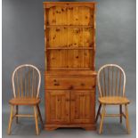 A small pine dresser, the upper part fitted two open shelves, the base fitted two frieze drawers