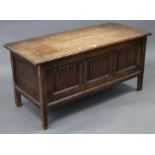 An oak coffer with hinged lift-lid, linen-fold panel front, & on short square legs, 42” wide x 20”