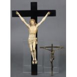 A carved ivory & ebonised wooden Corpus Christi, 14¼” high; & a brass Corpus Christi, 6¼” high.