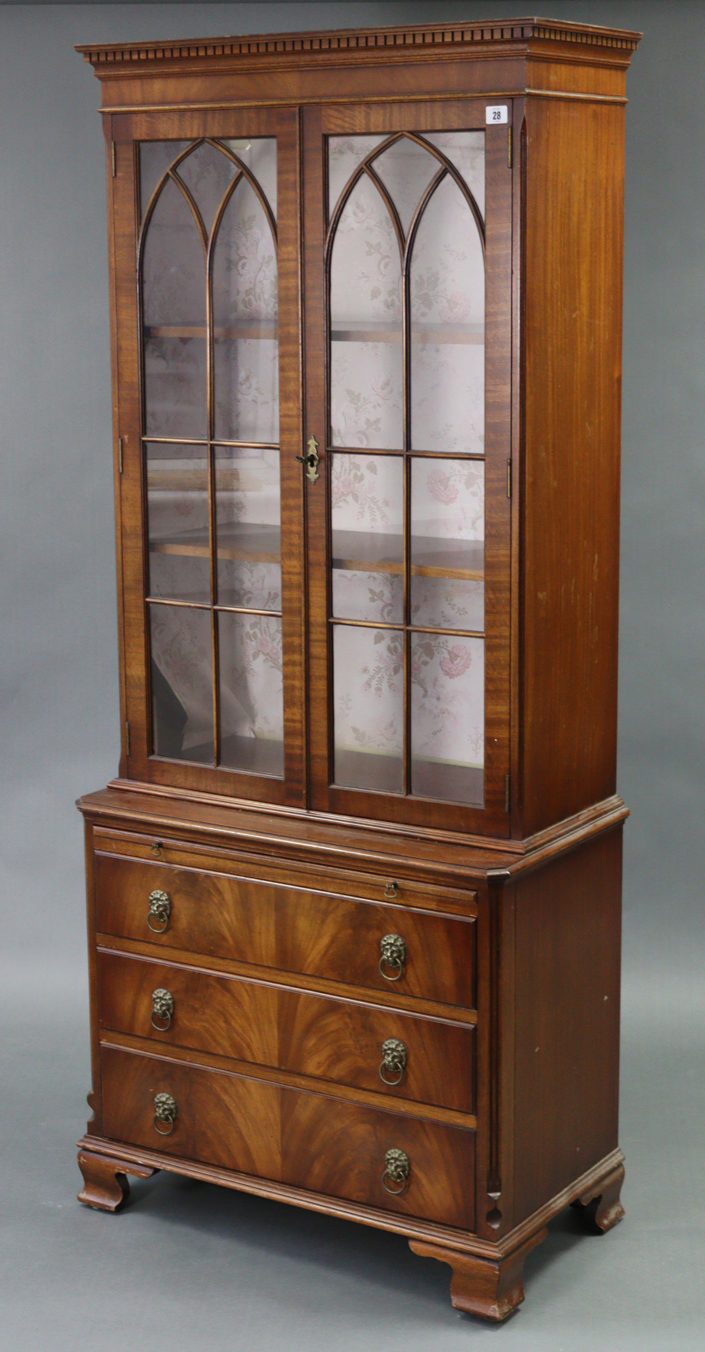A reproduction mahogany tall bookcase, the upper part with two adjustable shelves enclosed by pair