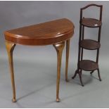 An Edwardian mahogany folding cake stand of three circular tiers, 36” high; & a mahogany demi-lune