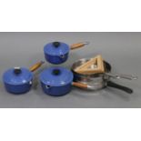 A set of three Le Creuset blue enamelled graduated saucepans with turned wooden handles, 7¾”,