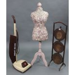 An Edwardian oak folding cake stand of three circular tiers, 35” high; together with a dressmaker’