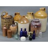 Five various stoneware flagons; together with various other stoneware jars & glass bottles, part w.