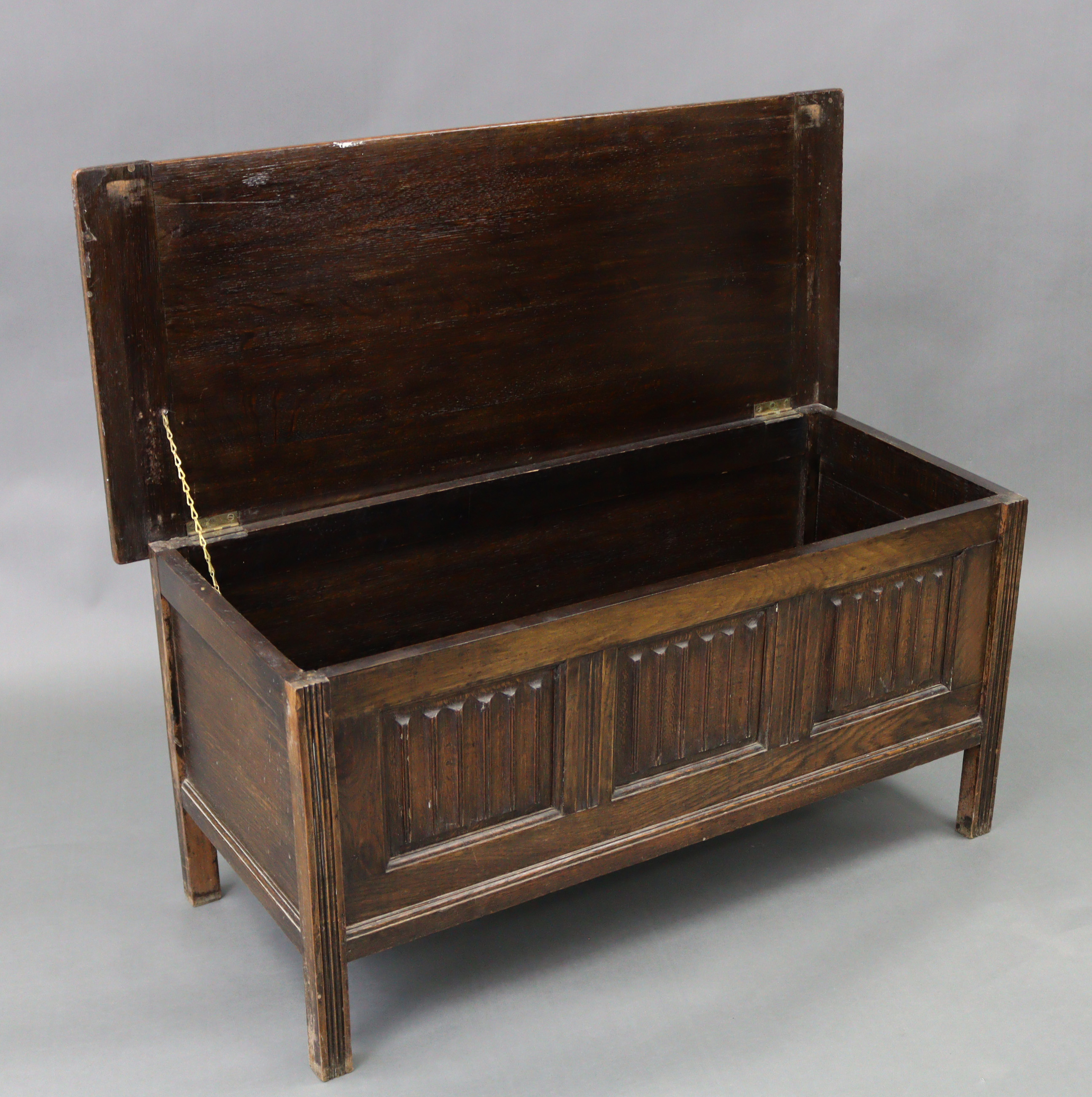 An oak coffer with hinged lift-lid, linen-fold panel front, & on short square legs, 42” wide x 20” - Image 2 of 3