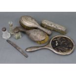 Two silver backed hair brushes; a ditto hand mirror & clothes brush; a silver comb mount; & three