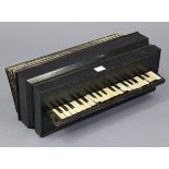 An early /mid-20th century Busson of Paris ebonised wooden accordion, 18¼” long.