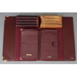 A Dunhill crimson leather wallet, 7½” x 5”; a Cartier of Paris crimson leather blotter cover, 11¾” x