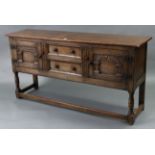 A GOOD QUALITY REPRODUCTION OAK SIDEBOARD fitted two long graduated drawers to centre flanked by