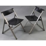 A pair of silvered-metal & black plastic fold-away chairs after a design by Justus Kolburg.