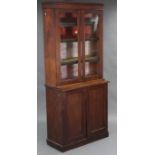 A late Victorian walnut bookcase, fitted three adjustable shelves enclosed by pair of glazed