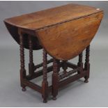 An 18th century joined oak & elm gate-leg table with drop leaves to the oval top, on bobbin-turned