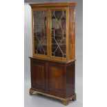 A late Victorian walnut bookcase with moulded cornice, fitted three adjustable shelves enclosed by a