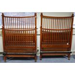 A pair of Edwardian mahogany single bedsteads, each head & footboard fitted with a pair of ball