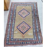 A Caucasian rug, decorated with two central diamond motifs,