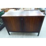 A 1970s rosewood finished cocktail cabinet, having straight sides,