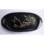 An early 20thC Japanese black lacquered and moulded hardwood oval pin tray,