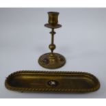 A late 19thC gilt brass candlestick, having a vase shaped socket and wide drip pan,