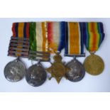 Five British military medals on ribbons and a bar brooch,