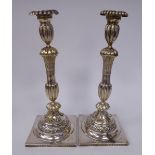 A pair of late 19thC Russian silver candlesticks of reed moulded form with cast and etched floral