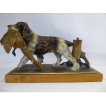 A 20thC Austrian spelter model novelty table lighter, fashioned as a gundog with captured dead game,