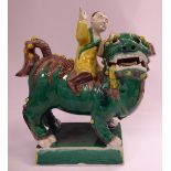 An early 20thC Chinese biscuit glazed model, a boy riding a Kylin,